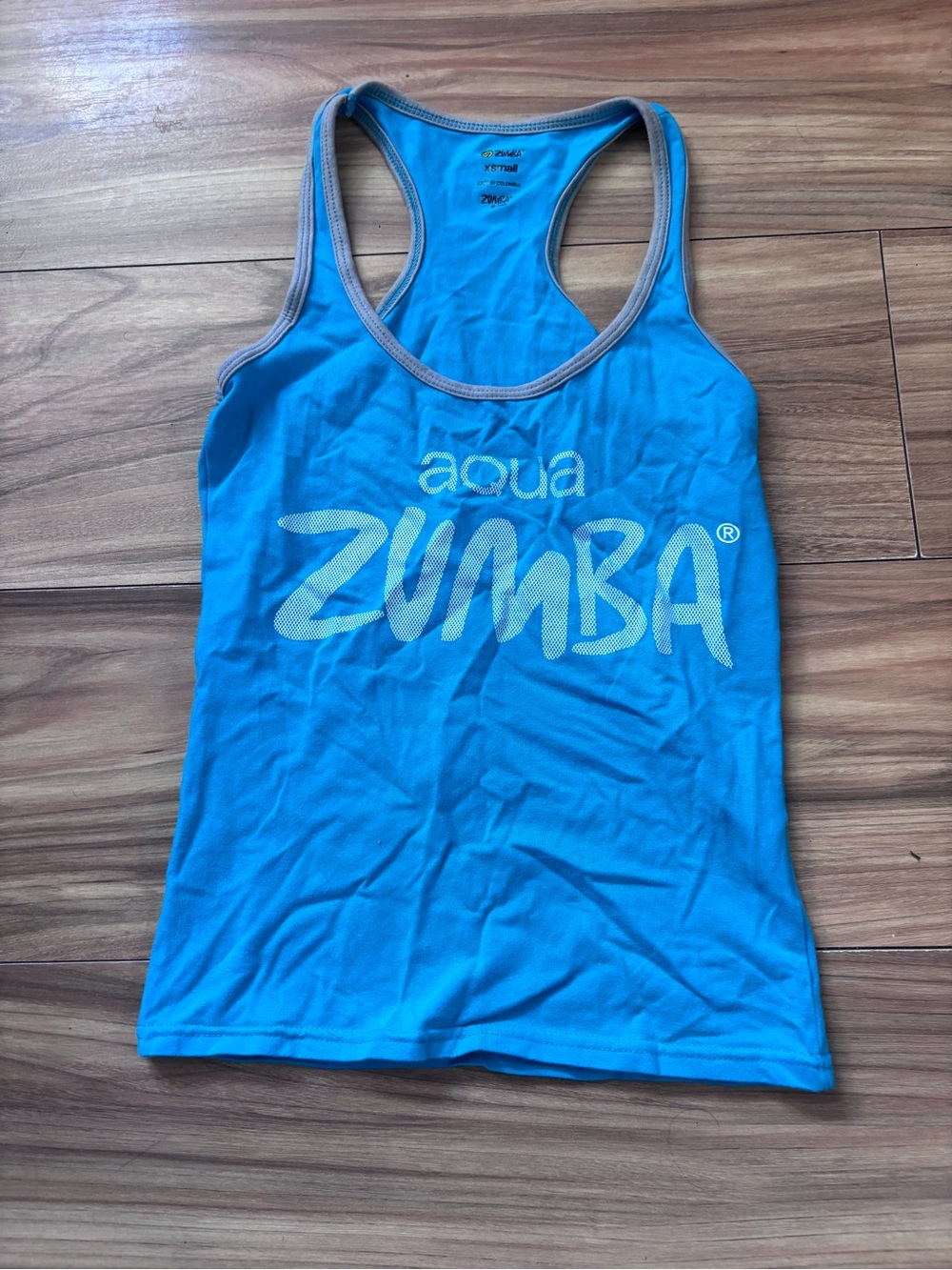 Blue Zumba tank top with white 'aqua ZUMBA' text, size XS